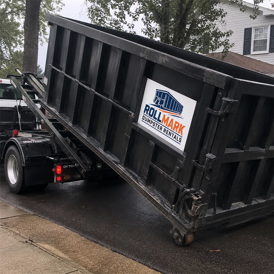 Black roll-off dumpster delivery for a cleanup project